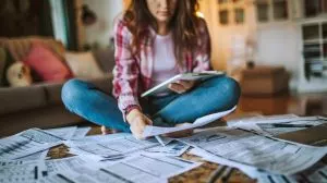 3.person-calculating-tax-returns-home-with-documents-laptop-300x168